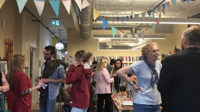 People standing and chatting in a colourful library