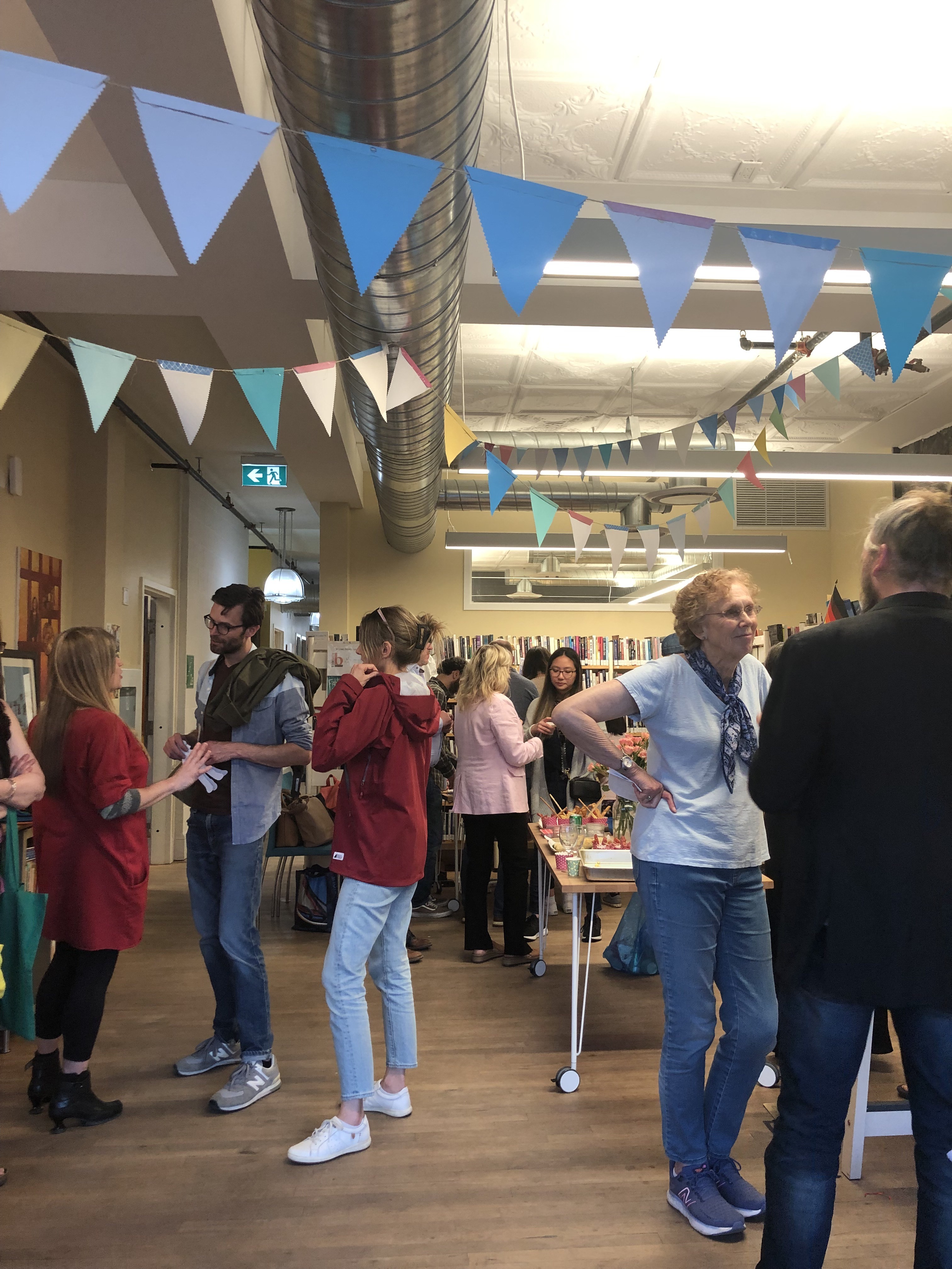 People standing and chatting in a colourful library