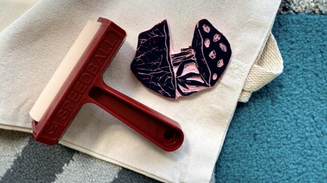 Printmaking tools on top of a textile.