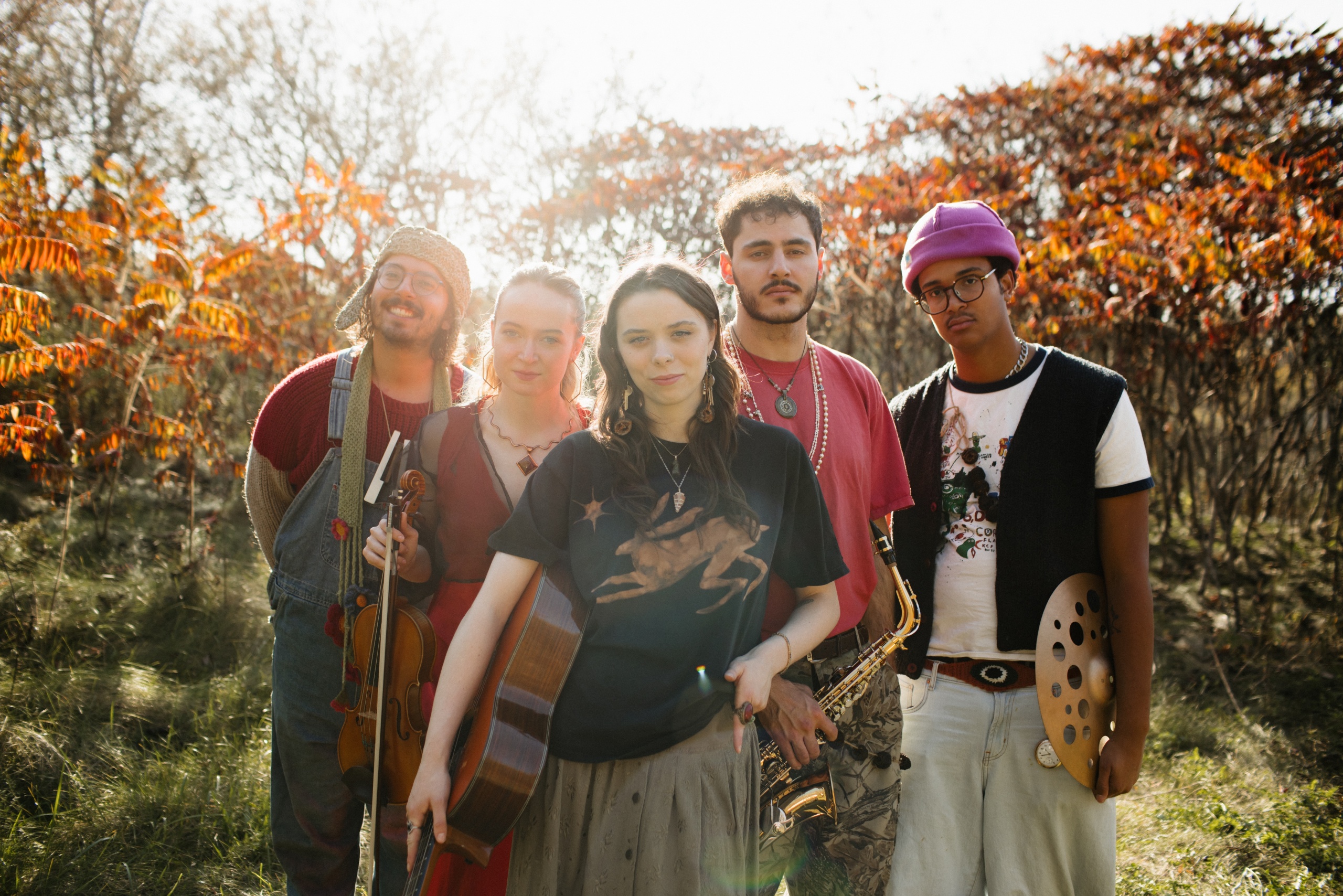 SHEBAD band members posing together in the sun.